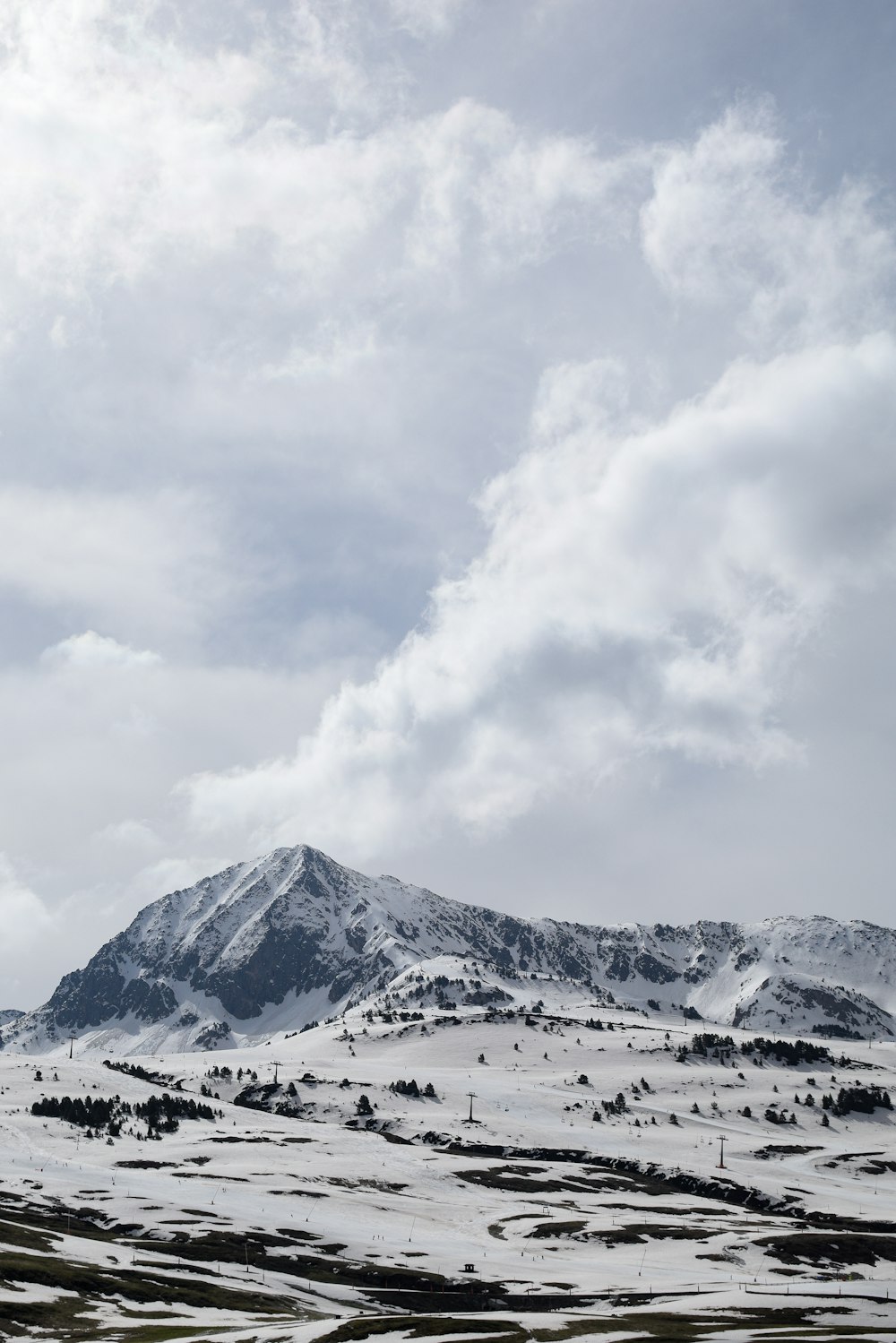 a snowy landscape with a mountain in the background