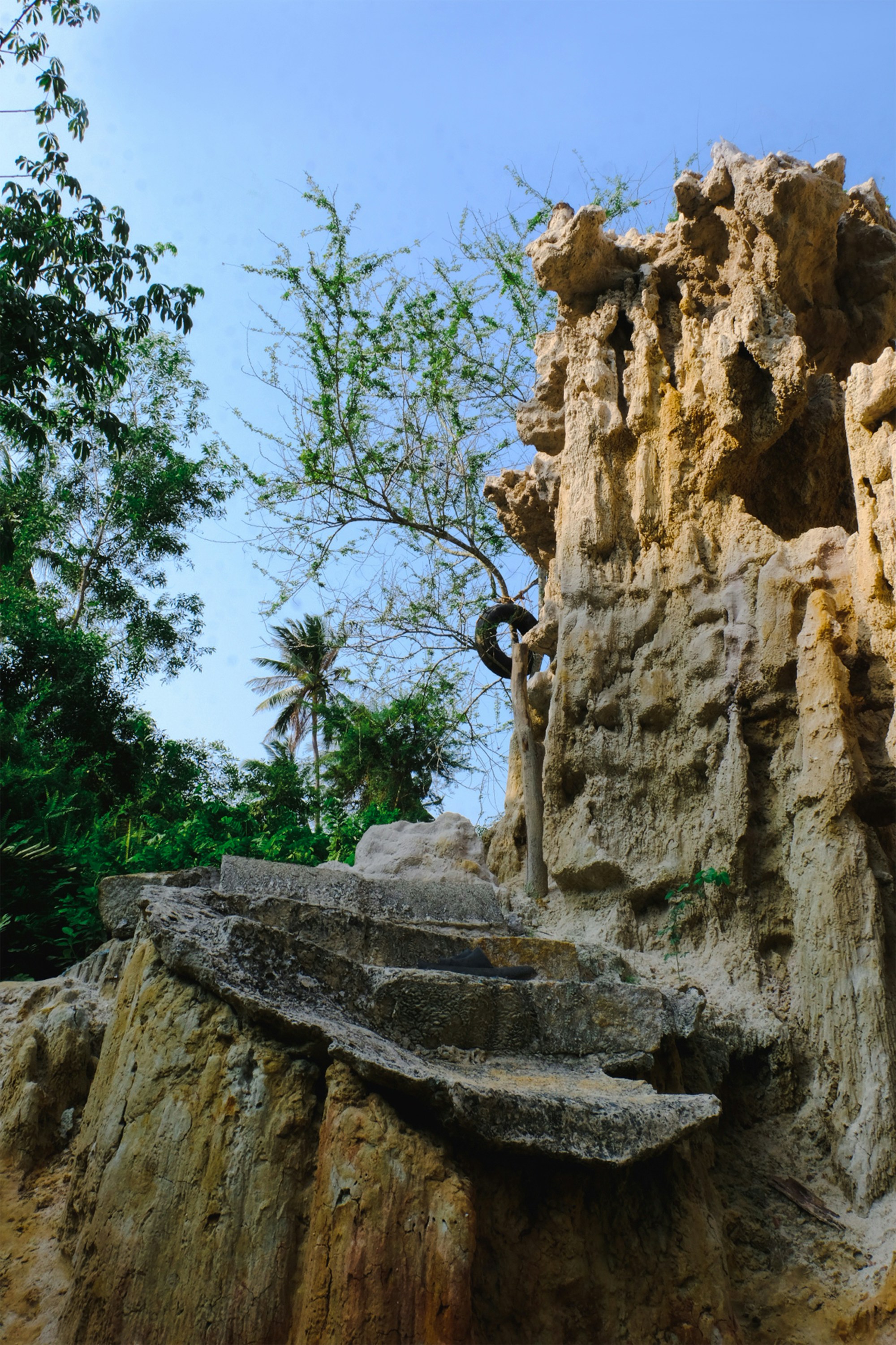 a rock formation with a bench in the middle of it