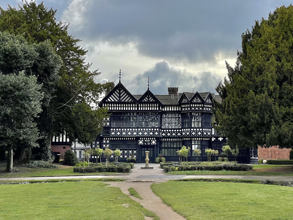 a large black and white house in a park