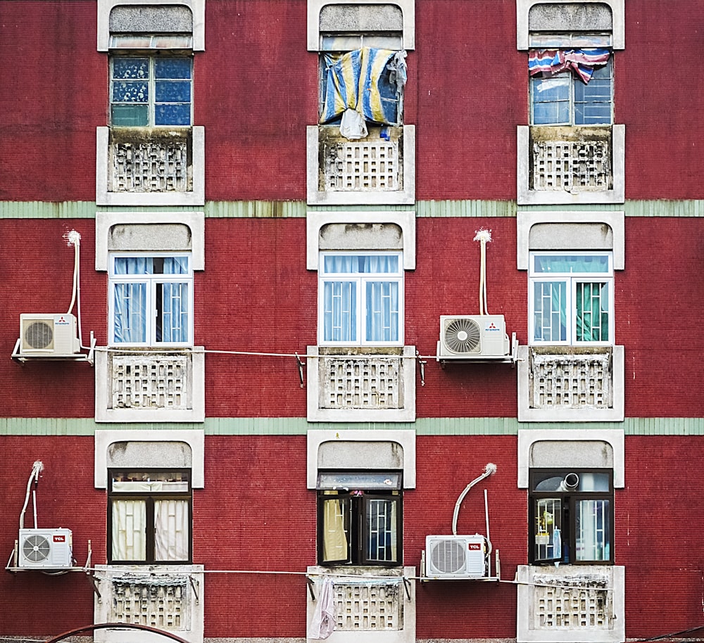 a red building with many windows and a clock