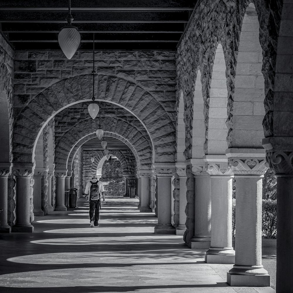 a person is walking down a long hallway