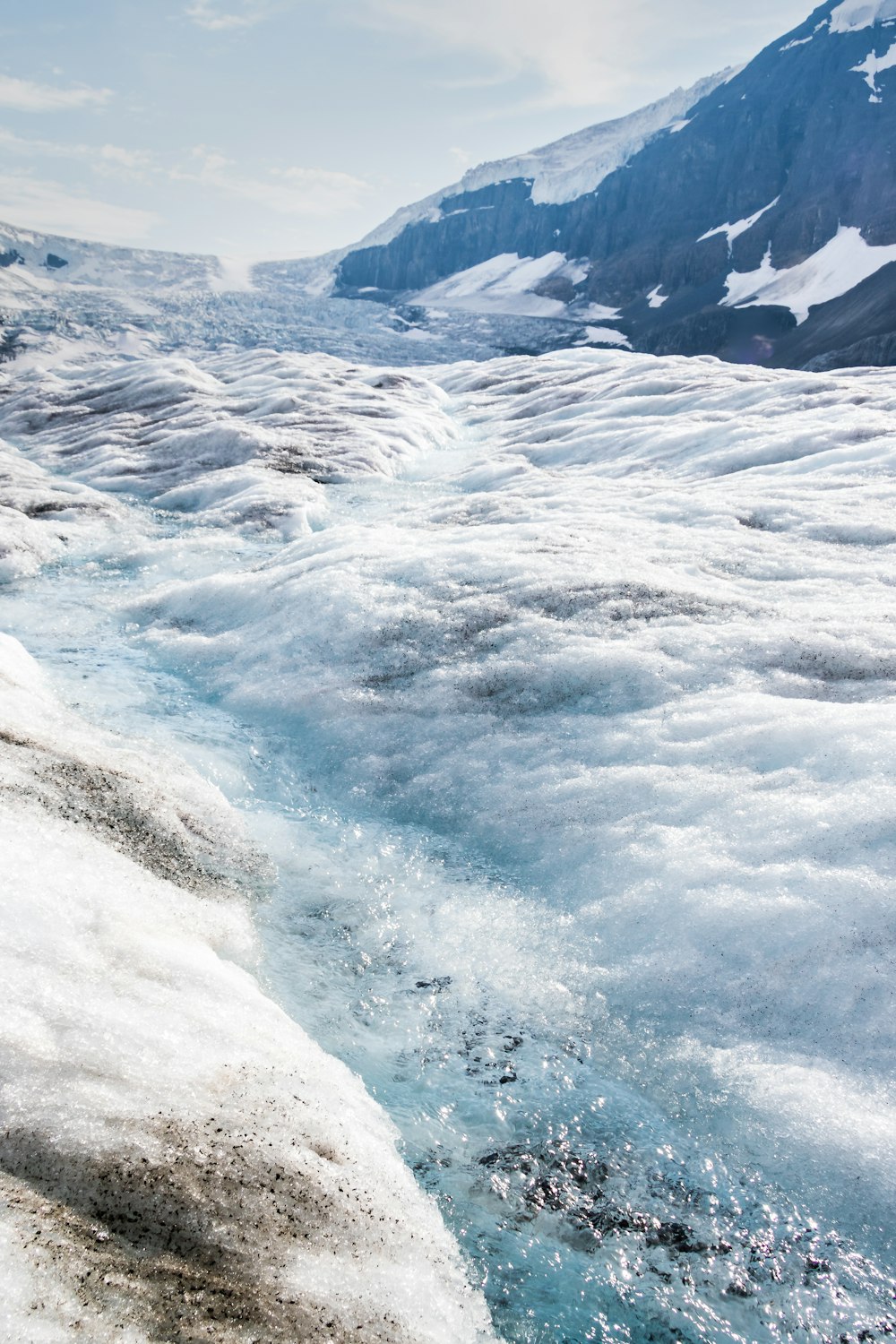 a river running through a snow covered mountain side