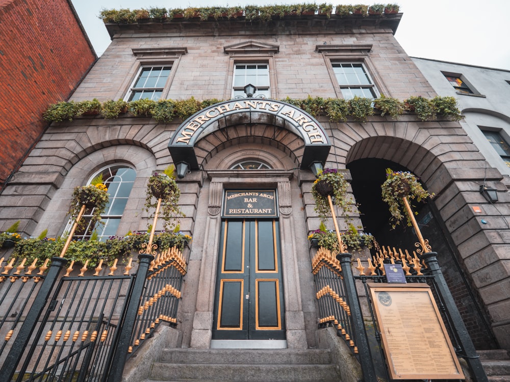 a tall building with a bunch of plants on it