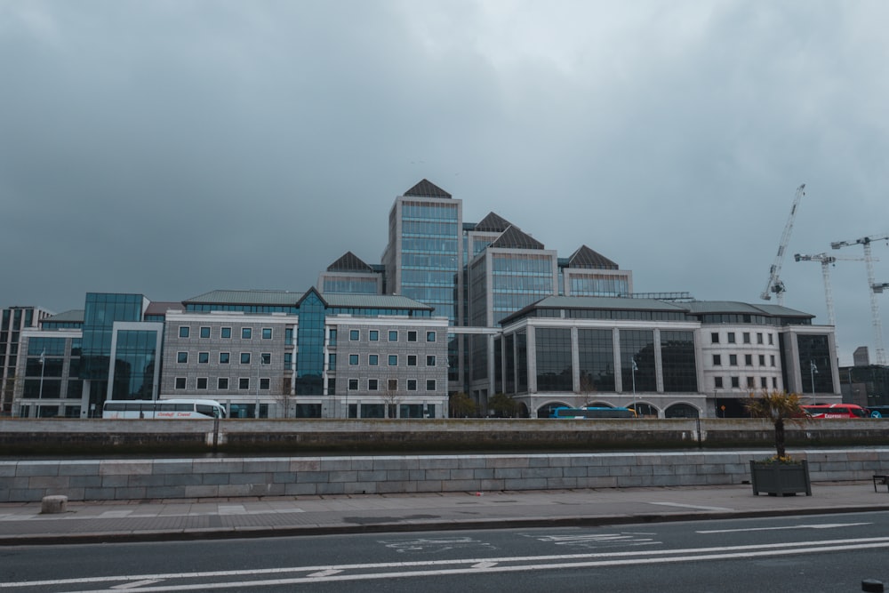 a large building with a lot of windows next to a street