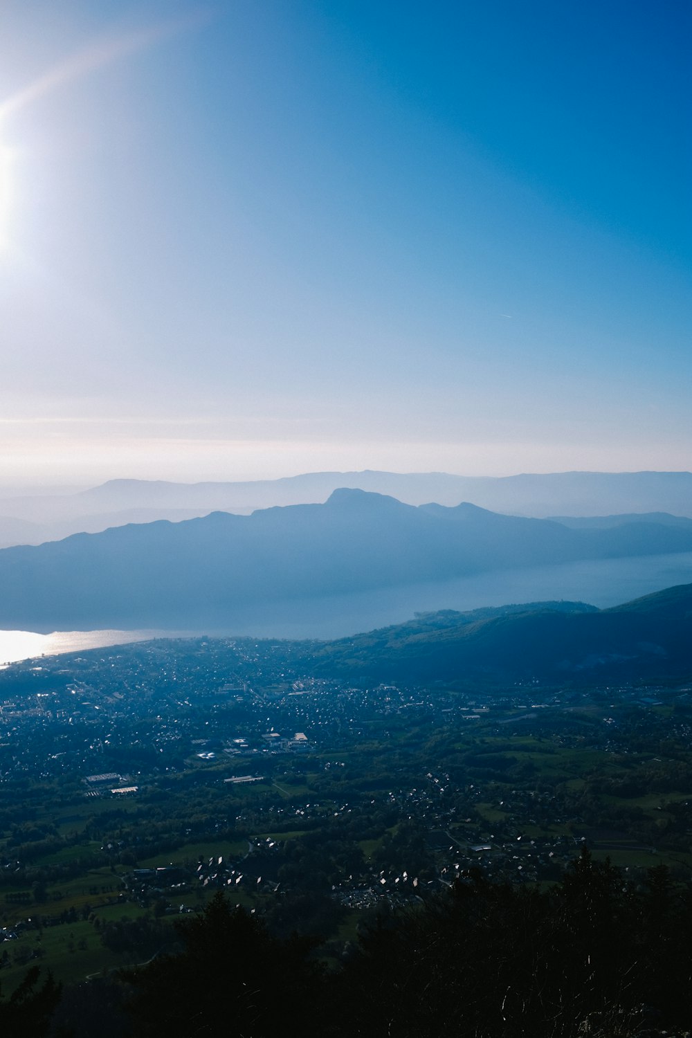 the sun is shining over the mountains and the water