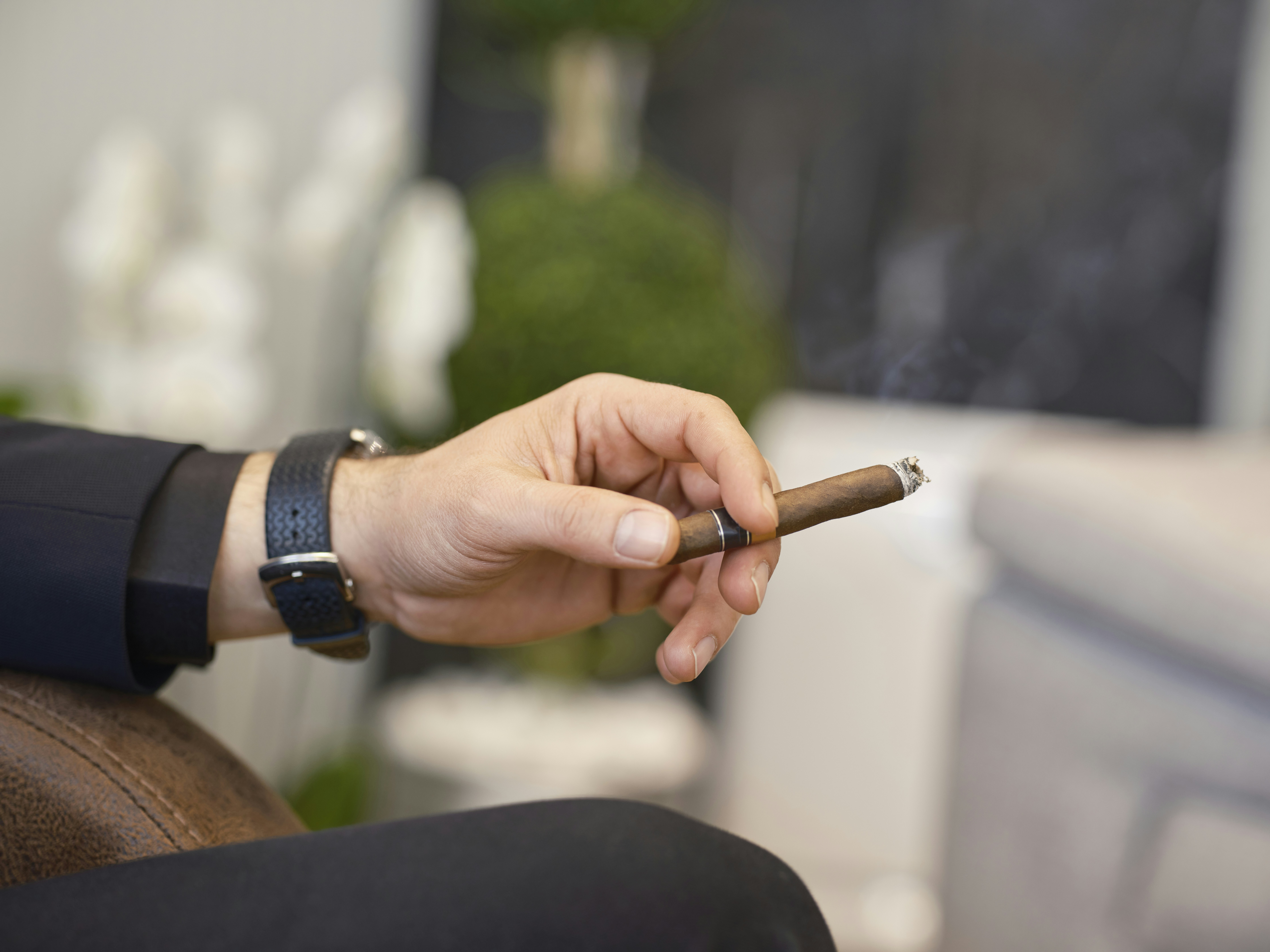 a person holding a cigarette in their hand