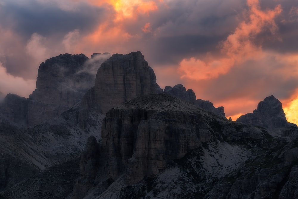 the sun is setting behind a mountain range