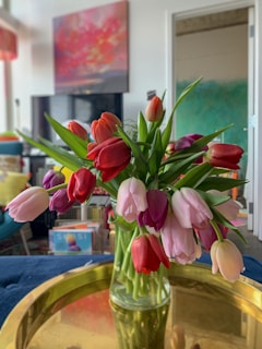 A happy customer holding a beautifully arranged Latinflor bouquet in a cozy home setting.