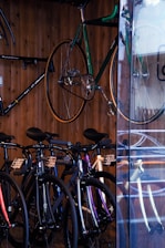 A variety of bicycles and tricycles neatly arranged inside a retail showroom.