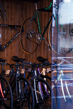 A collection of premium bicycles lined up, ready for customer pickup in a tidy service area.