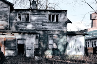 an old run down house with a clock tower