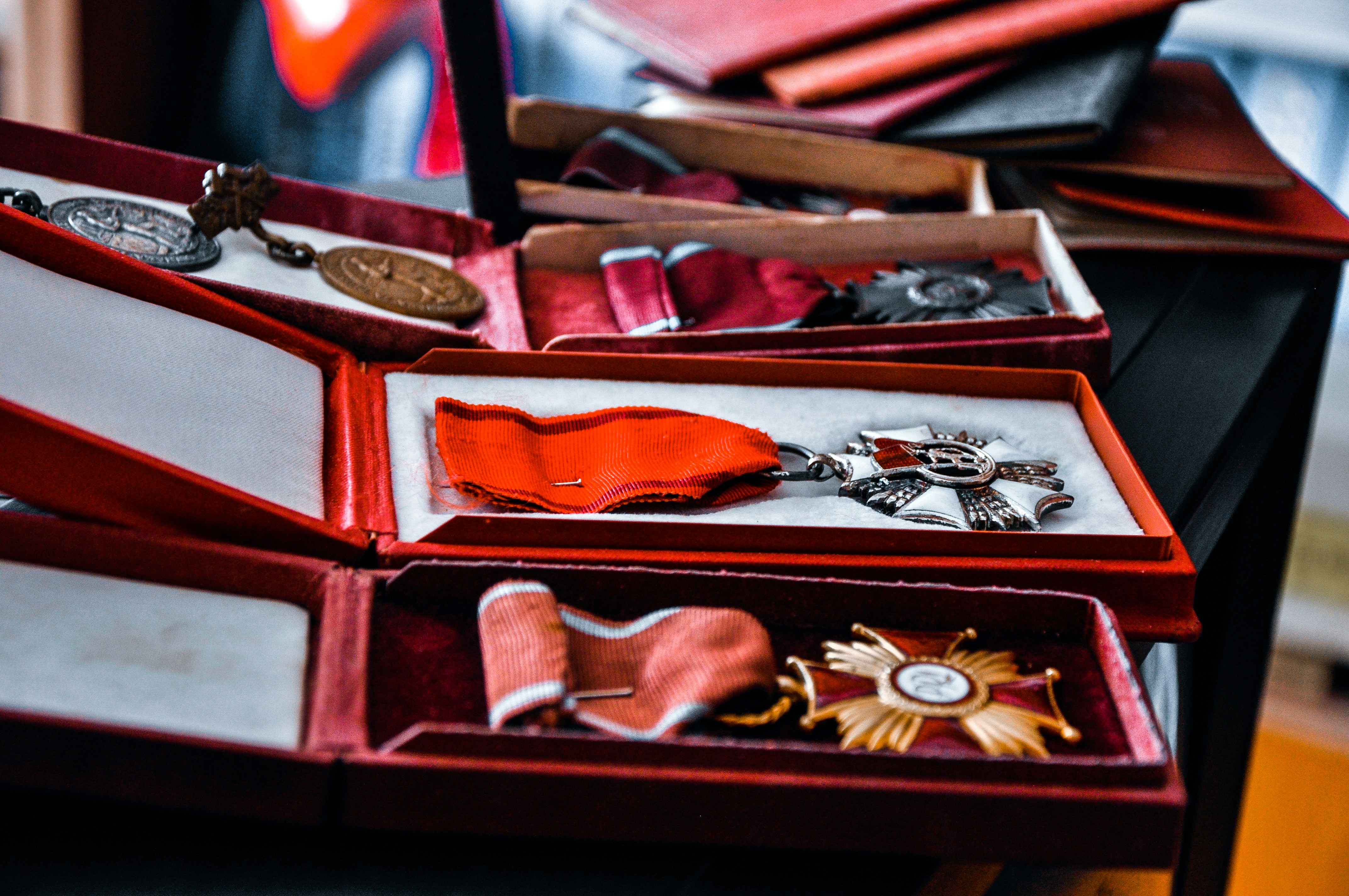 a bunch of medals are in a red box