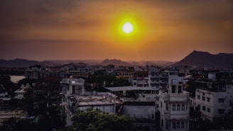 A vibrant sunset over the ancient city of Lahore, with its historic architecture glowing warmly.