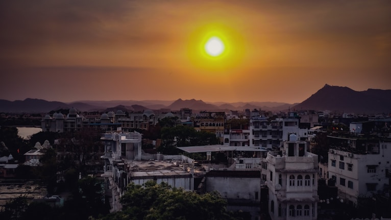 A sunset over an ancient cityscape blending heritage with modern life.