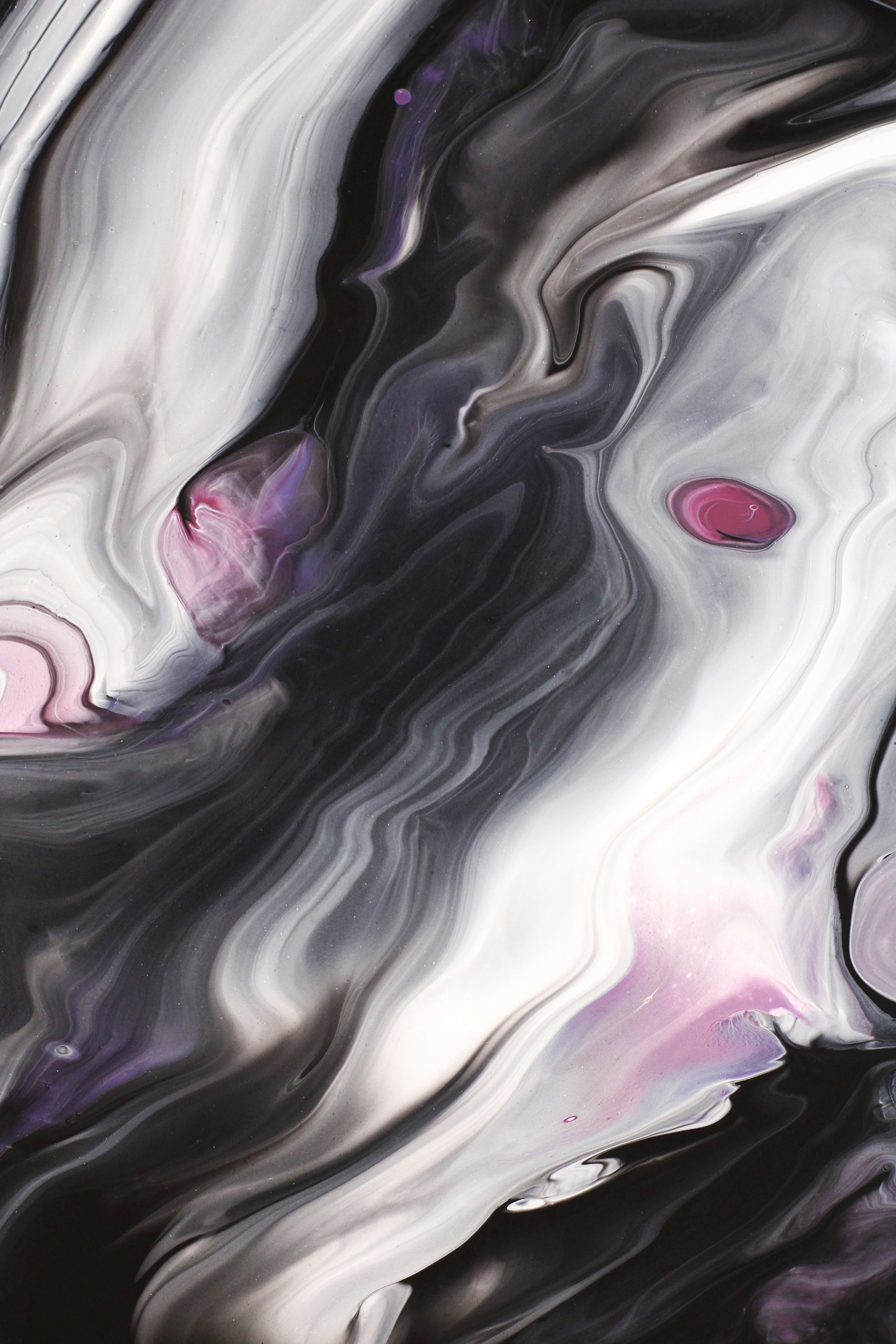 a black and white abstract painting with red dots