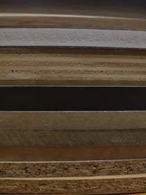 Stack of various WPC door models showcasing different finishes and styles.