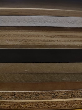 Stack of natural wood veneer sheets neatly arranged on a wooden table.