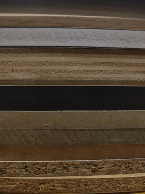 Stack of various wooden tissue boxes showing different wood finishes and styles.