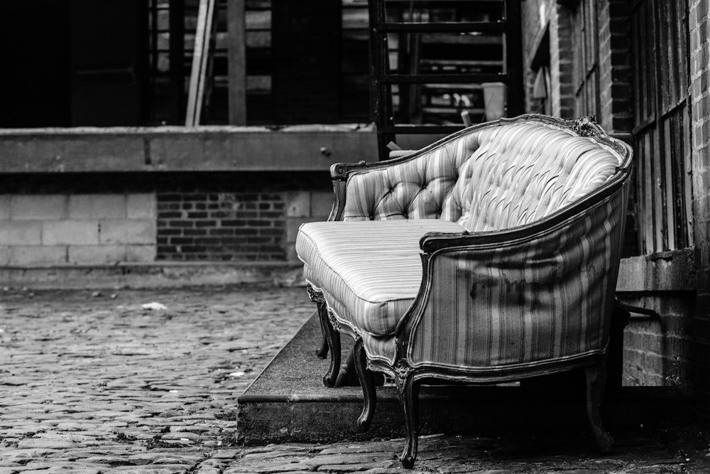 a couch sitting on the side of a building