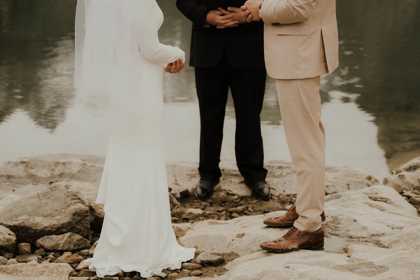 Couple in elopement attire in a colonial setting during their Sucre Bolivia elopement with the white colonial architecture and the city context behind them