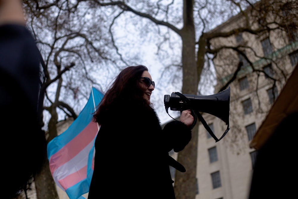 a woman holding a megaphone and a flag