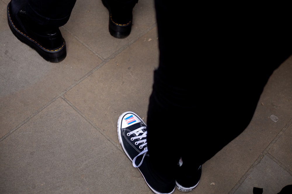 a pair of black and white shoes on the ground