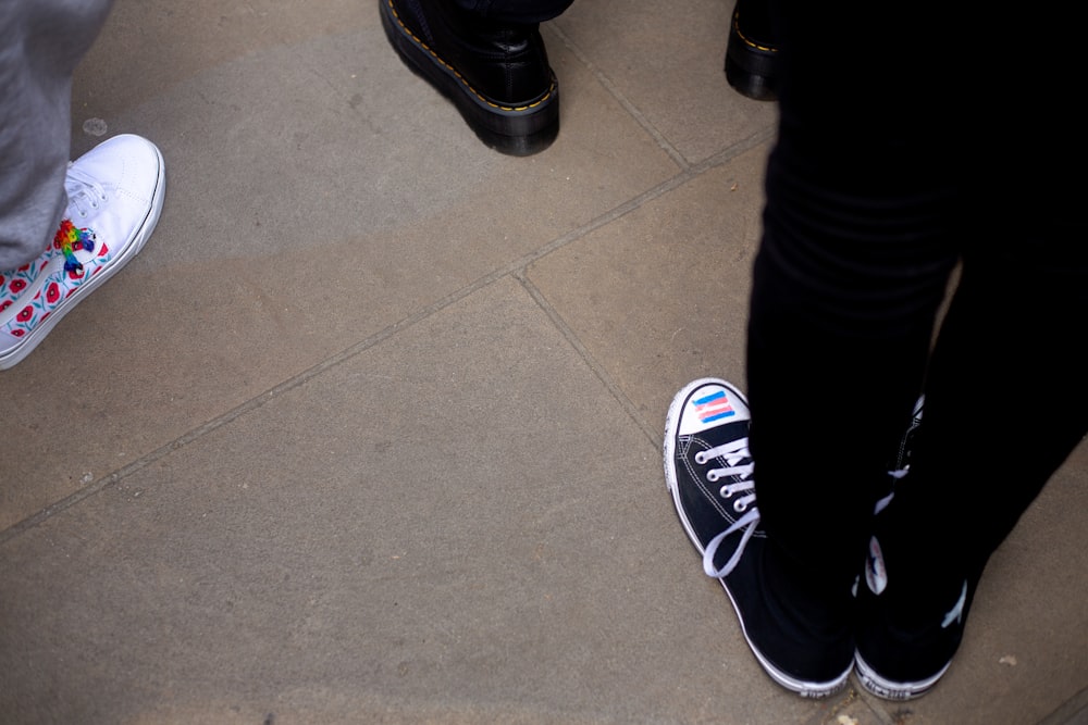 a group of people standing next to each other on a sidewalk