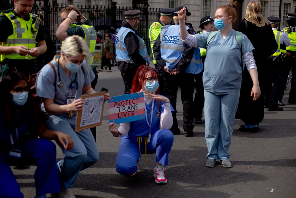 a woman with a face mask holding a sign