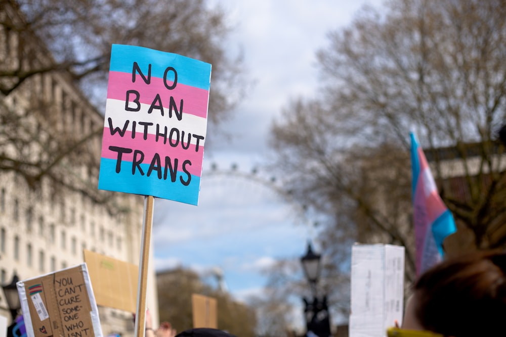 a protest with a sign that says no ban without trains