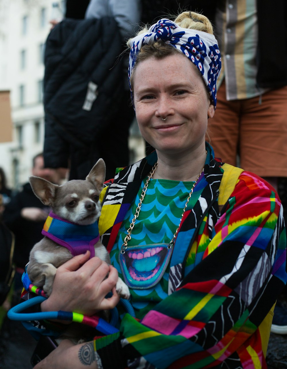 a woman holding a small dog in her arms