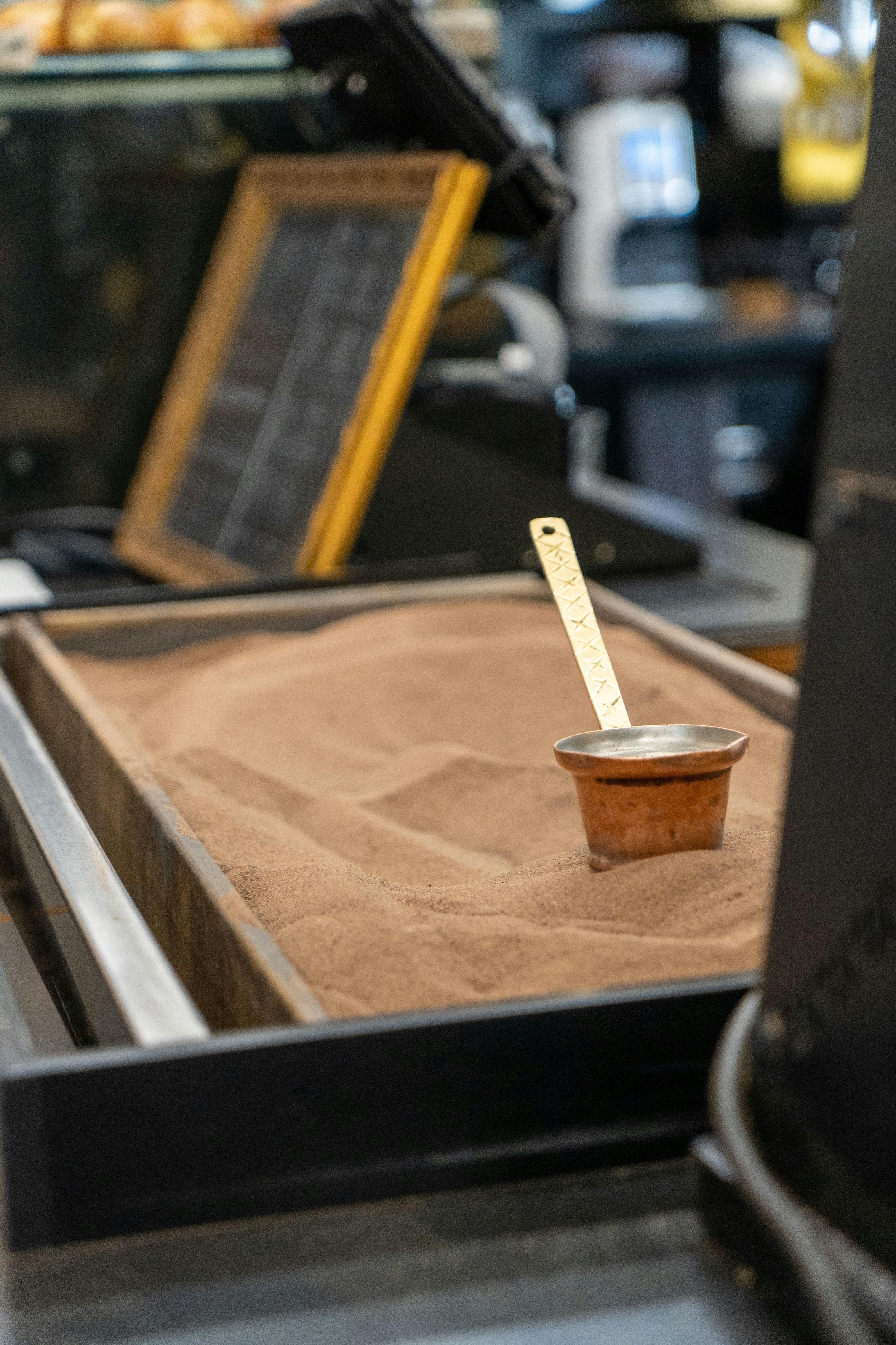 A bowl of sand with a ruler sticking out of it photo – Free Wood Image ...