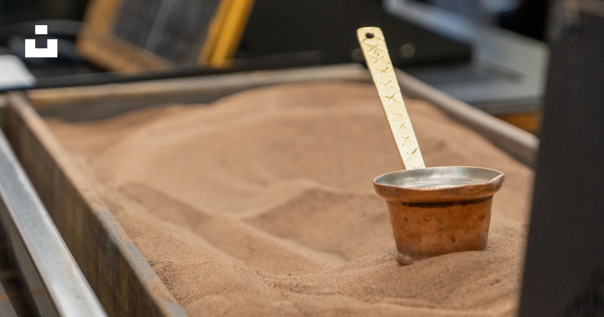 A bowl of sand with a ruler sticking out of it photo – Free Wood Image ...