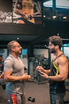 A friendly personal trainer discussing fitness plans with clients.