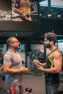 Athlete and manager discussing career strategy in a gym setting.