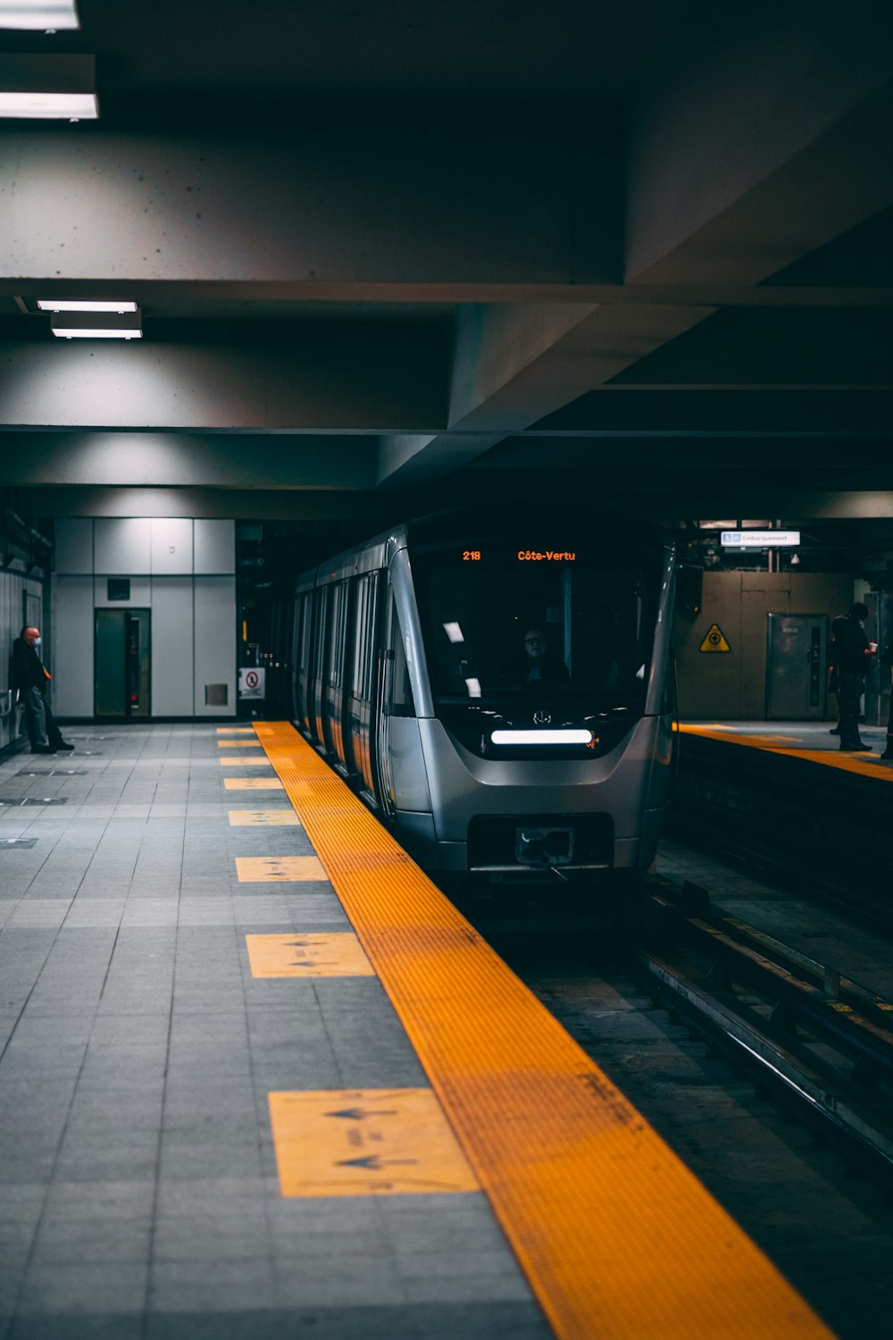 a subway train pulling into a train station