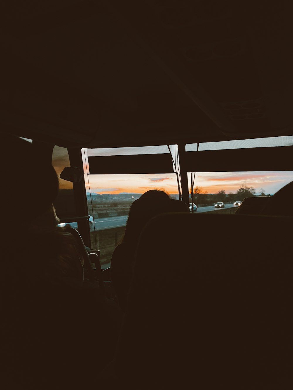 a person sitting in a car looking out the window