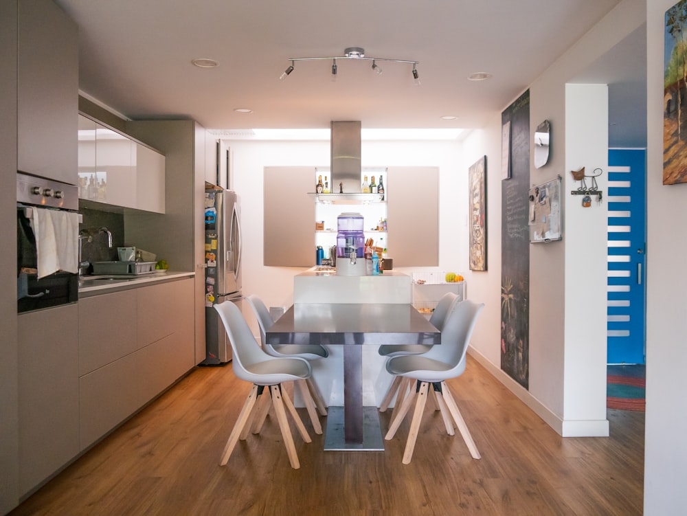 a kitchen with a table and chairs in it