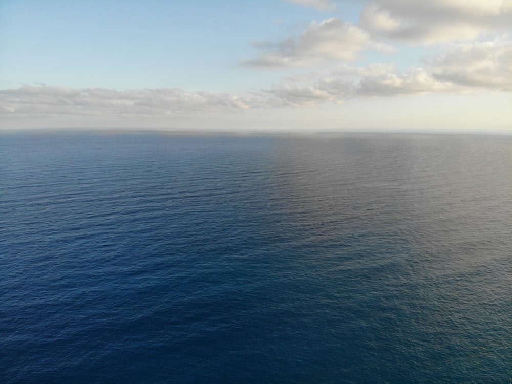 a large body of water under a cloudy sky