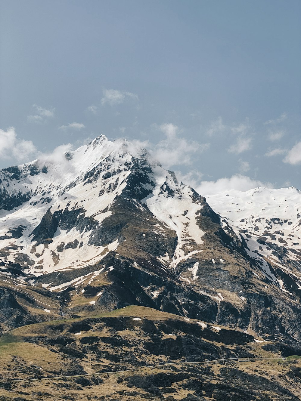 a mountain covered in snow under a blue sky