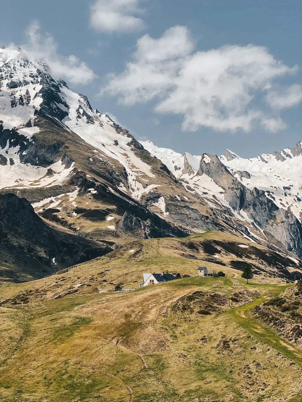 a view of a mountain range with a house in the foreground