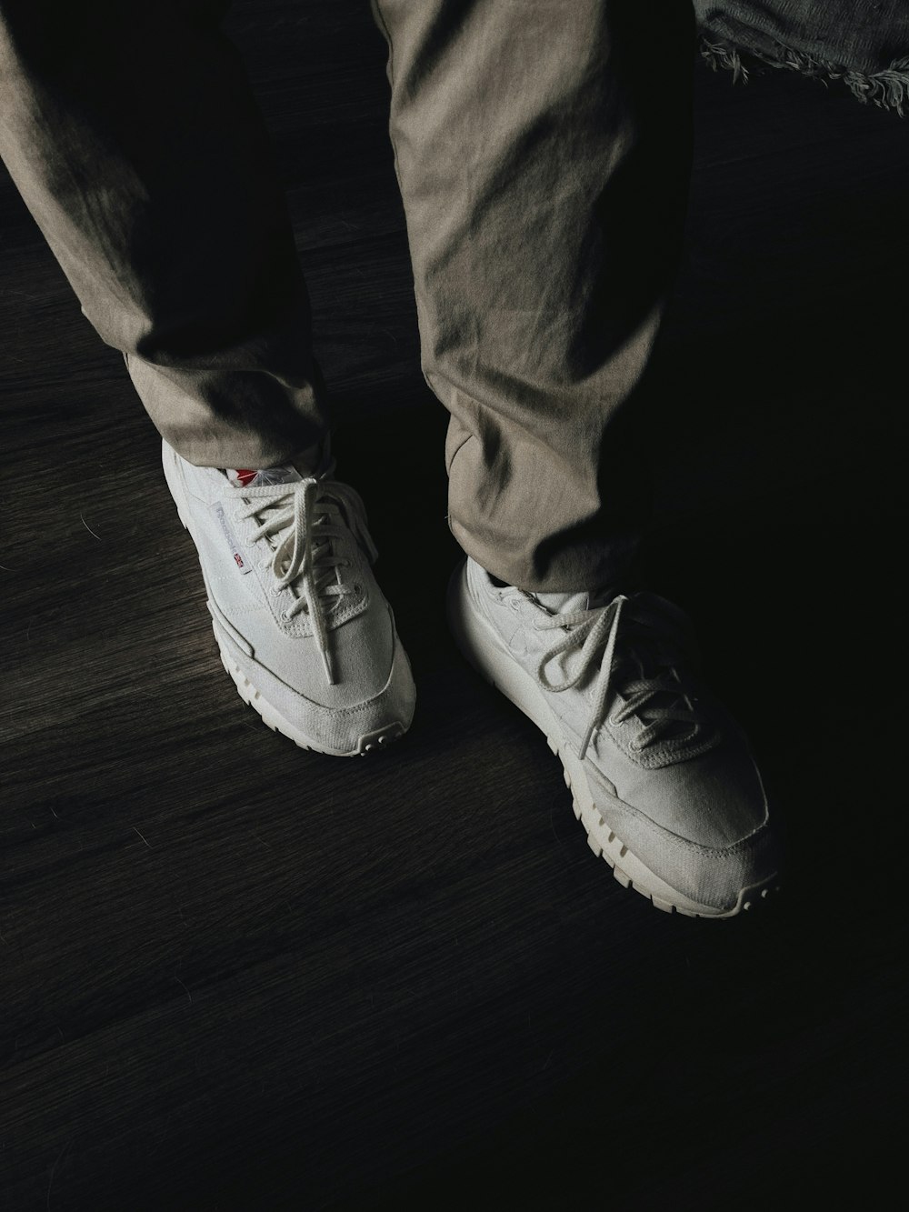 a person standing on top of a wooden floor