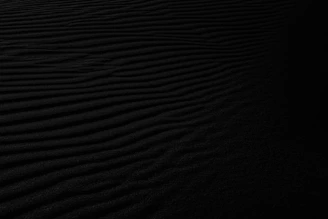 a black and white photo of a sand dune