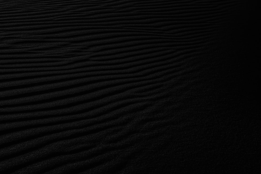 a black and white photo of a sand dune