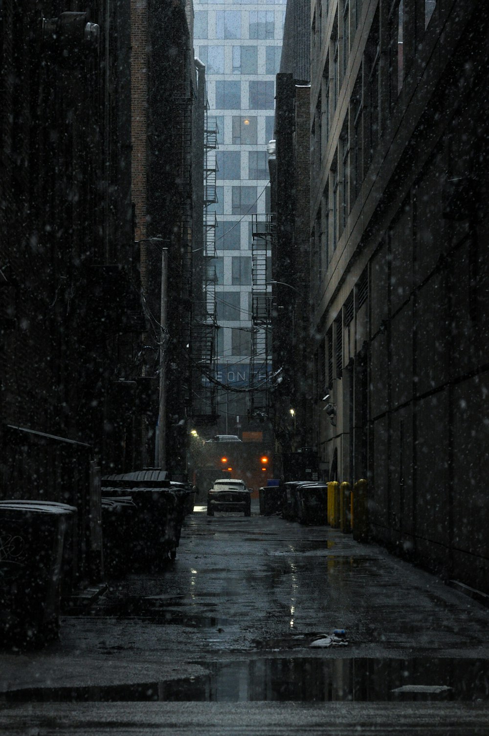 a city street with buildings and a traffic light in the rain