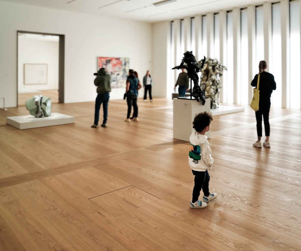 a group of people standing around a museum