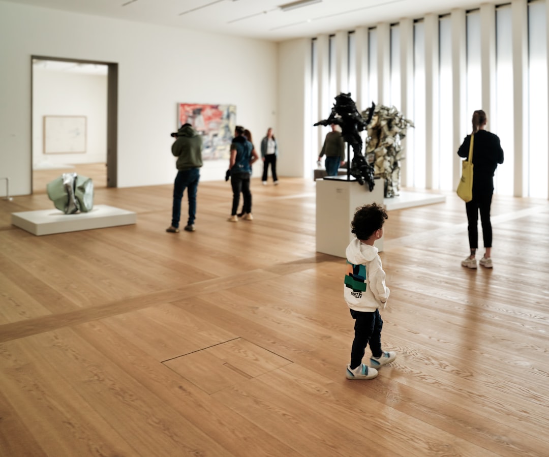 a group of people standing around a museum, The future artist