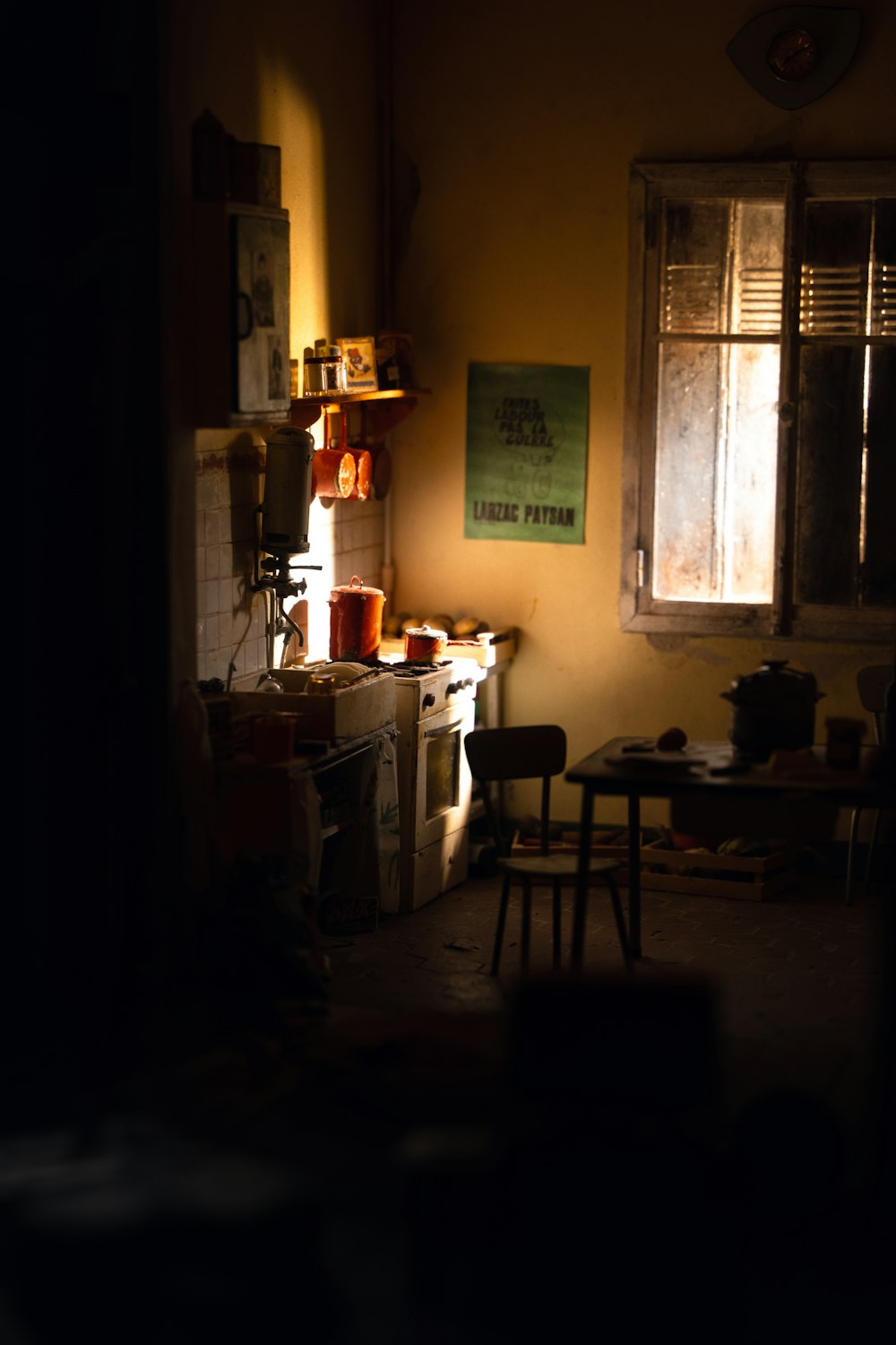 a dimly lit room with a table and chairs