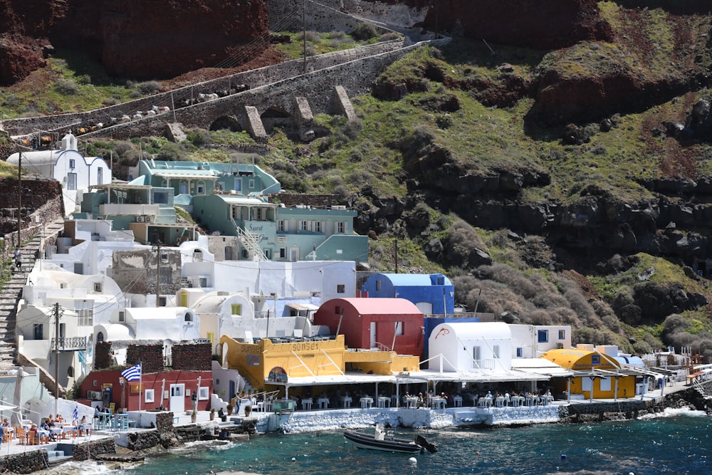 a boat is in the water next to a row of houses