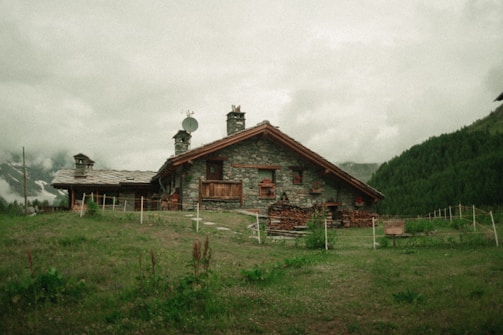 a stone house with a clock tower on top of it