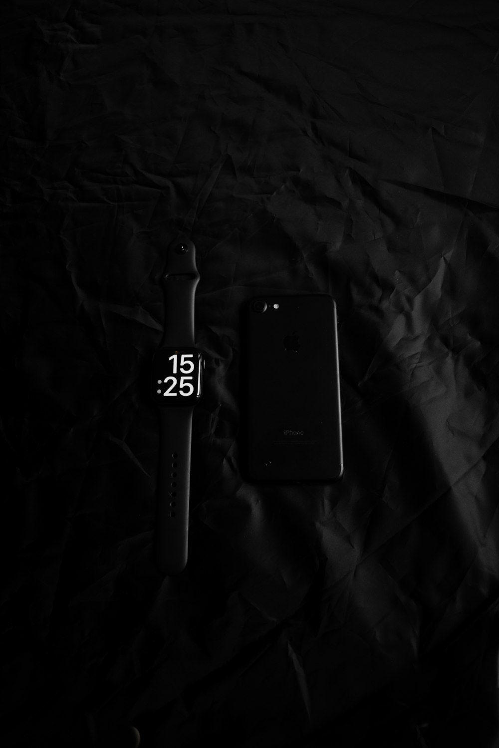 a cell phone sitting next to a smart watch